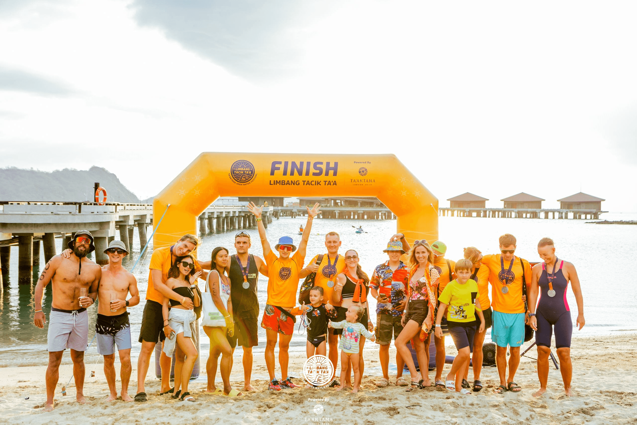 Open-water camp participants beside the race finish arch in the Komodo Islands, 2024