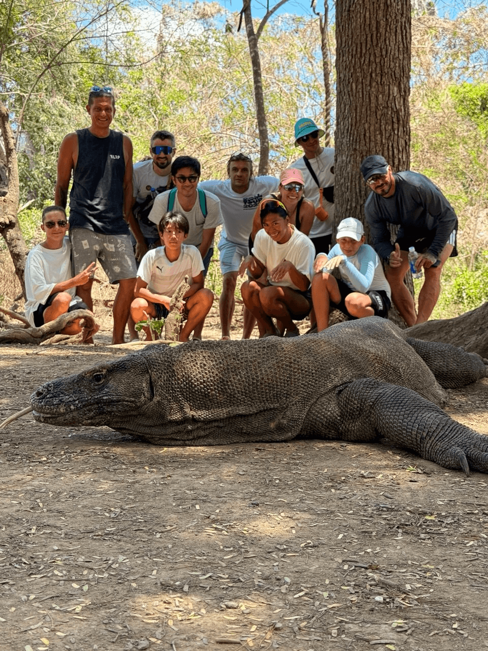 The team exploring Komodo, with a Komodo dragon in the foreground