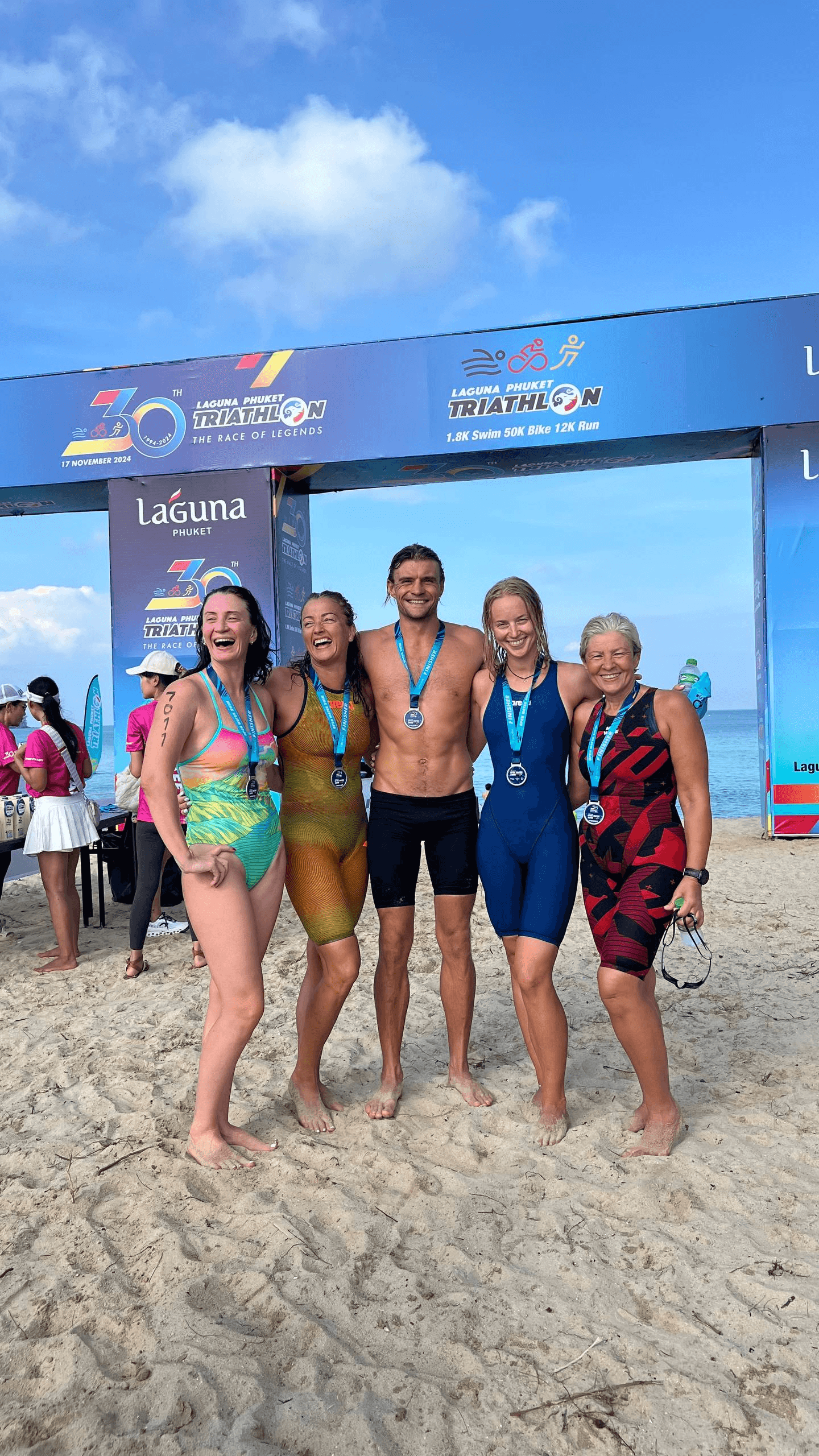 Camp participants with medals at the Laguna Phuket open-water camp and race, 2024